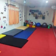 Therapist working with a child on a developmental exercise